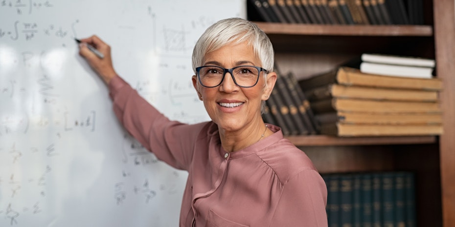 a female professor writing on a board