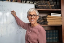 a female professor writing on a board