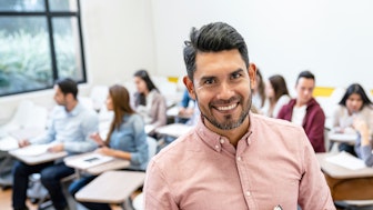 A happy junior professor in his class